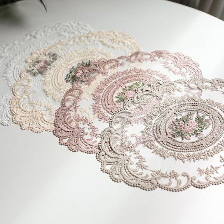 French lace table mat laid on a dining table